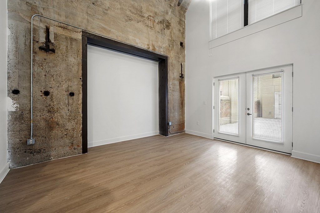 A room with a white door and a window with blinds.