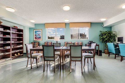 a dining room with a large table and chairs