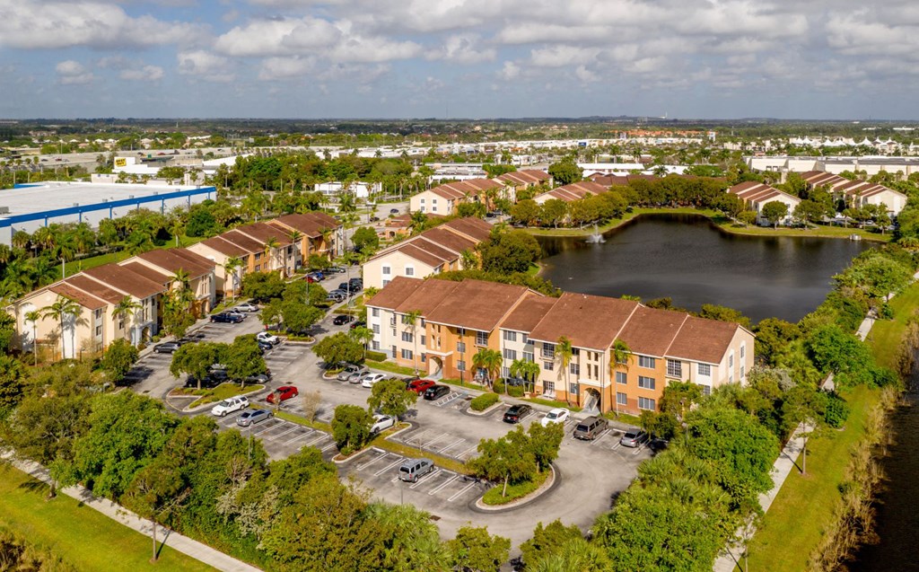 an aerial view of a row of houses next to a lake