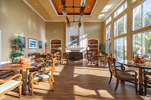 A large dining room with wooden floors and furniture.