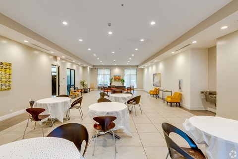 A dining room with tables and chairs.