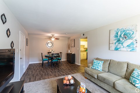 A living room with a couch, a coffee table, and a television.at Bradley Square, North Charleston, SC  