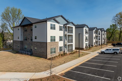 A row of townhouses with a white van parked in the driveway at Dunean Creek Apartments, Greenville, SC