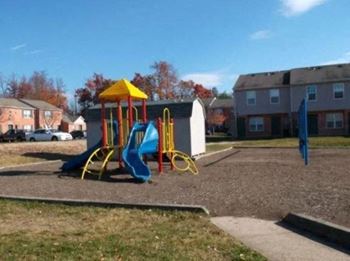 A playground with a yellow and blue slide.