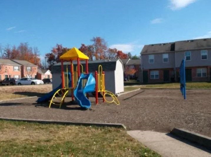 a playground with a blue and yellow swing set at Crescent Pointe, Stafford, VA