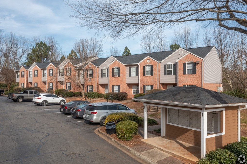 a row of apartment buildings with cars parked in a parking lot at Canaan Pointe, Greenville, South Carolina