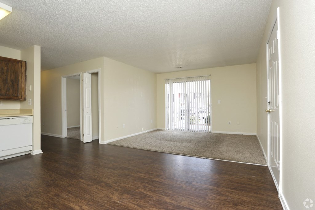 an empty living room with wood flooring and a door to a balcony at Canaan Pointe, Greenville South Carolina