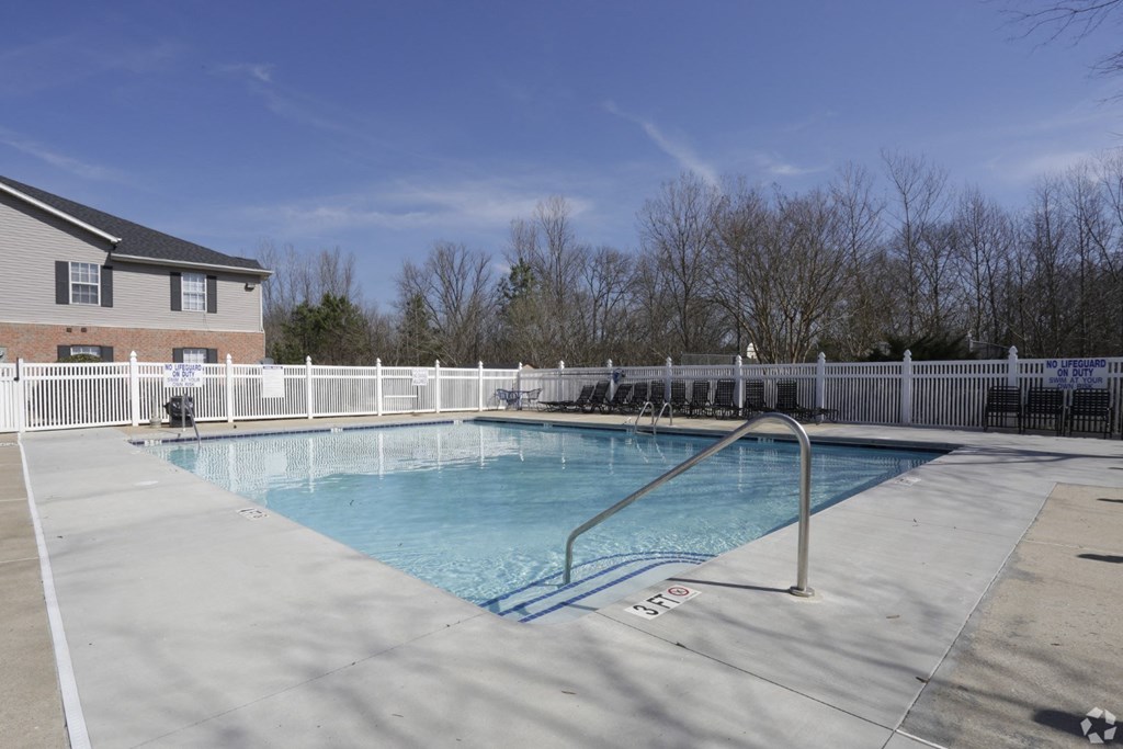 a resort style pool with a white fence and a house at Canaan Pointe, Greenville, 29607