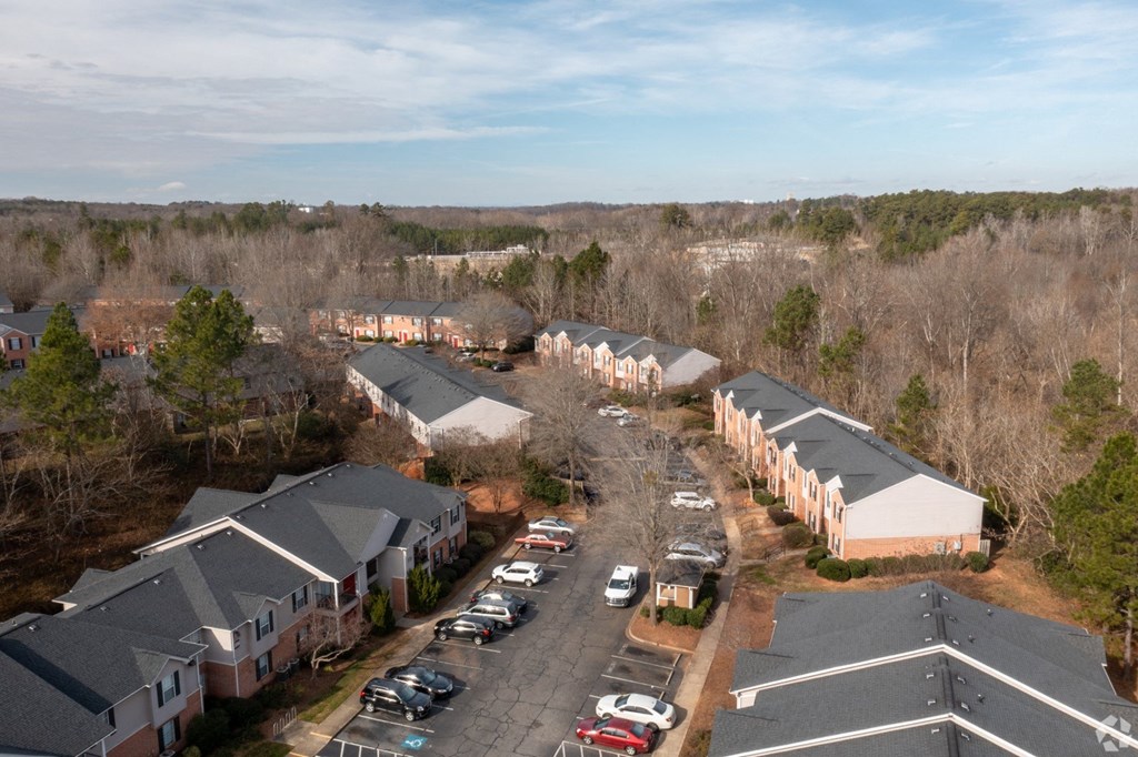 an aerial view of a neighborhood of houses with cars parked