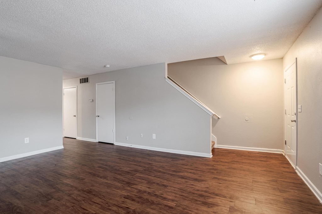 A room with wooden floors and white walls.