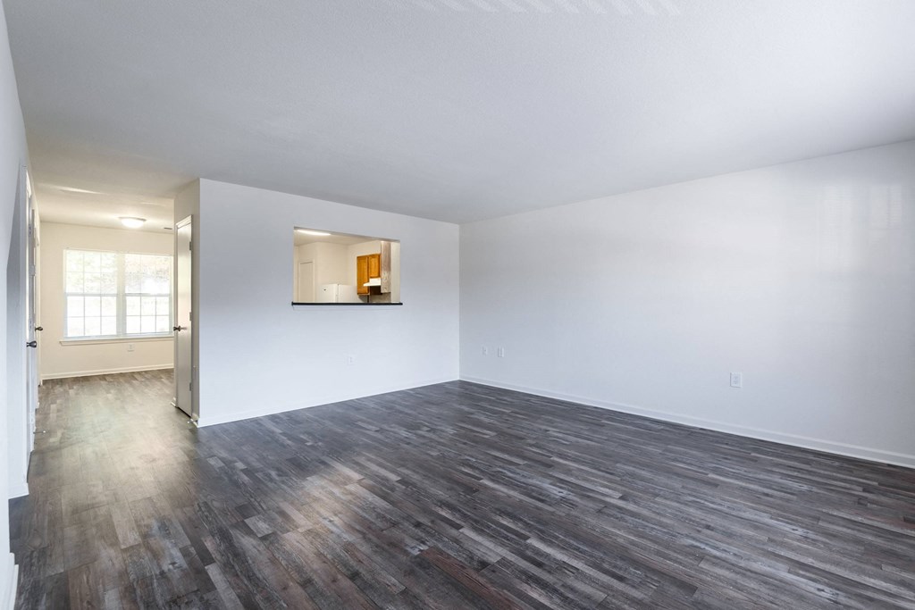 an empty living room with white walls and wood floors at Crescent Pointe, Stafford, 22554