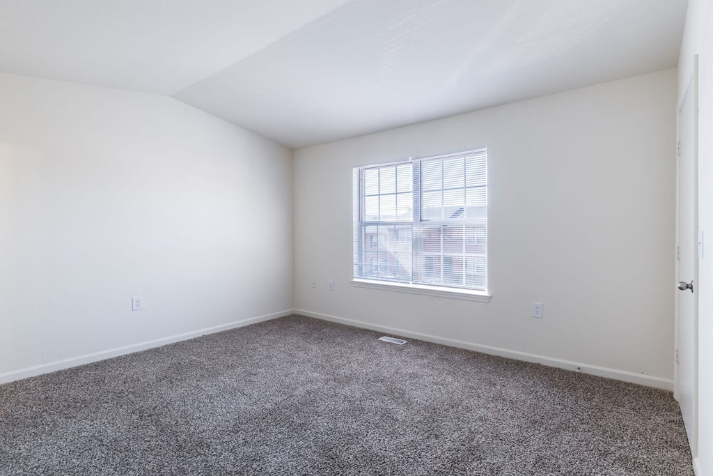 an empty room with carpet and a window at Crescent Pointe, Stafford, Virginia
