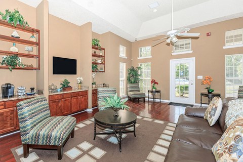 a living room with furniture and a ceiling fan