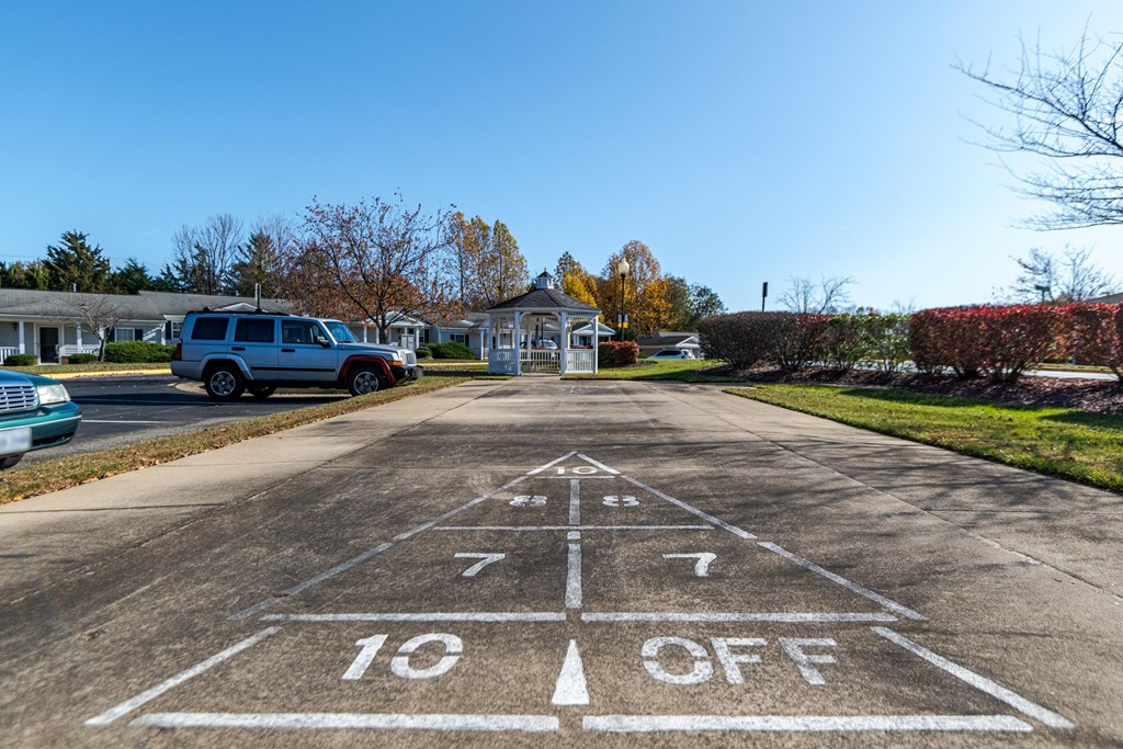 A parking lot with a white line painted on the pavement that says 10 off. at English Oaks Apartments, Fredericksburg, VA