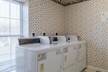 A wall with a dotted pattern is behind a white appliance.