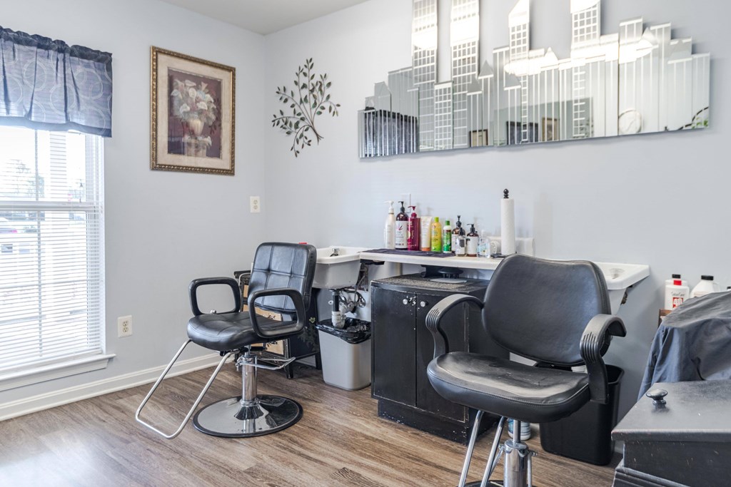 A hairdressing salon with two chairs and a mirror at English Oaks Apartments, Fredericksburg, Virginia