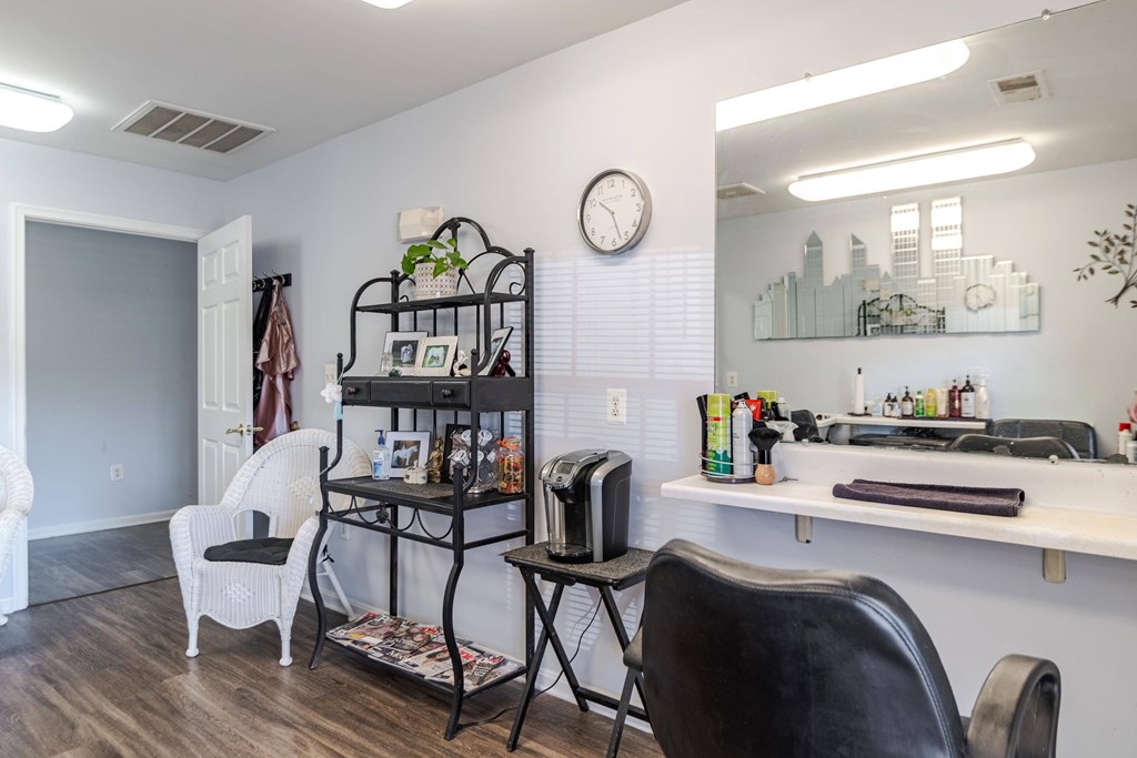 A room with a desk, chair, and a clock on the wall at English Oaks Apartments, Fredericksburg, 22406