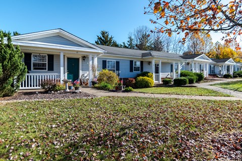 A row of houses with a green lawn in front at English Oaks Apartments, Fredericksburg, VA, 22406