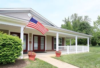 A house with an American flag hanging from the roof.