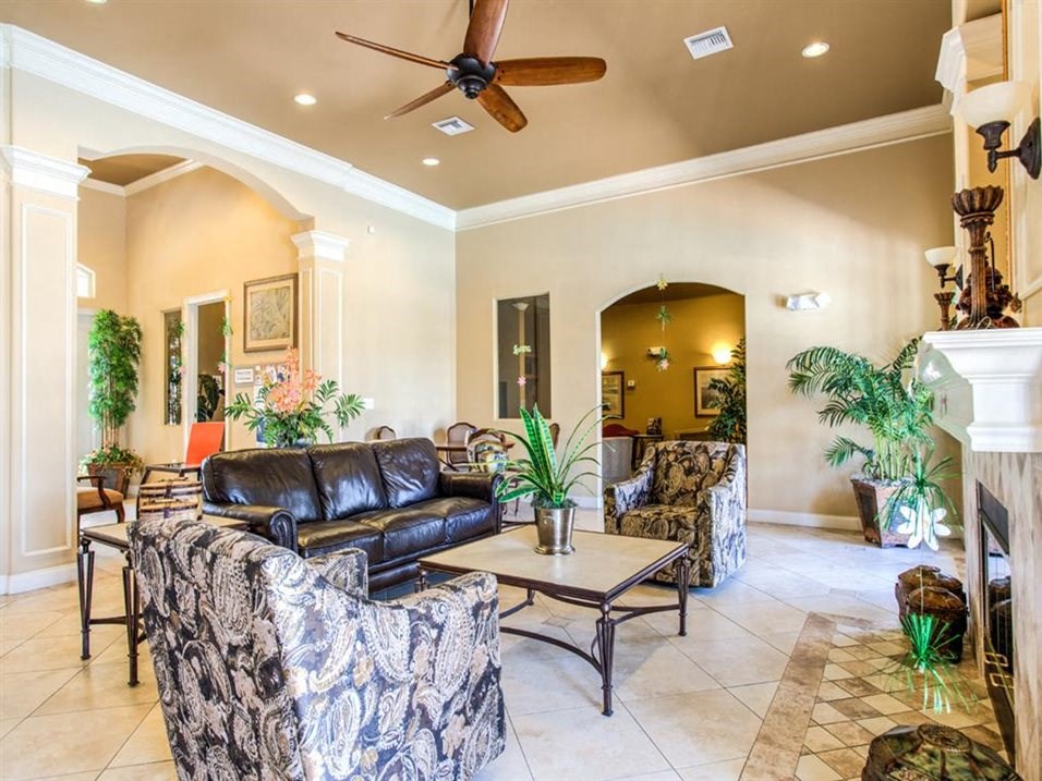 a living room filled with furniture and a ceiling fan