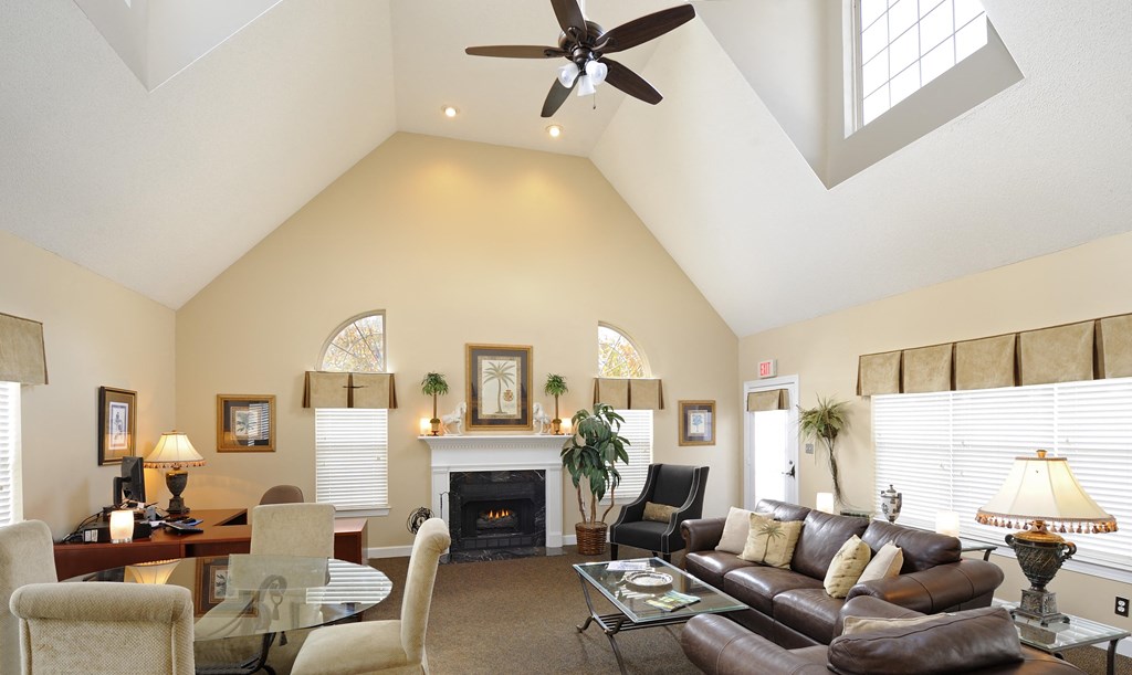 A living room with a fireplace and a ceiling fan.at Summerland Heights, Woodbridge, VA  