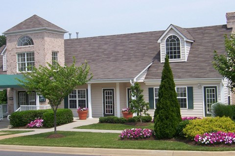 A house with a grey roof and a white front porch at Summerland Heights Apartments, Woodbridge, 22191