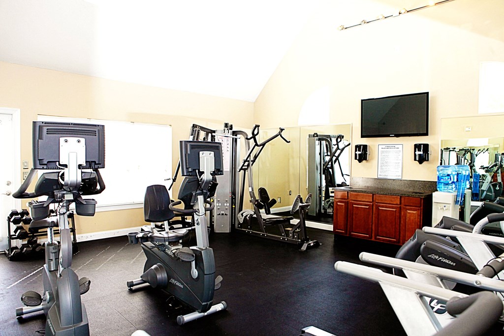A gym with a variety of exercise equipment including treadmills, stationary bikes, and weight machines.at Summerland Heights, Virginia, 22191