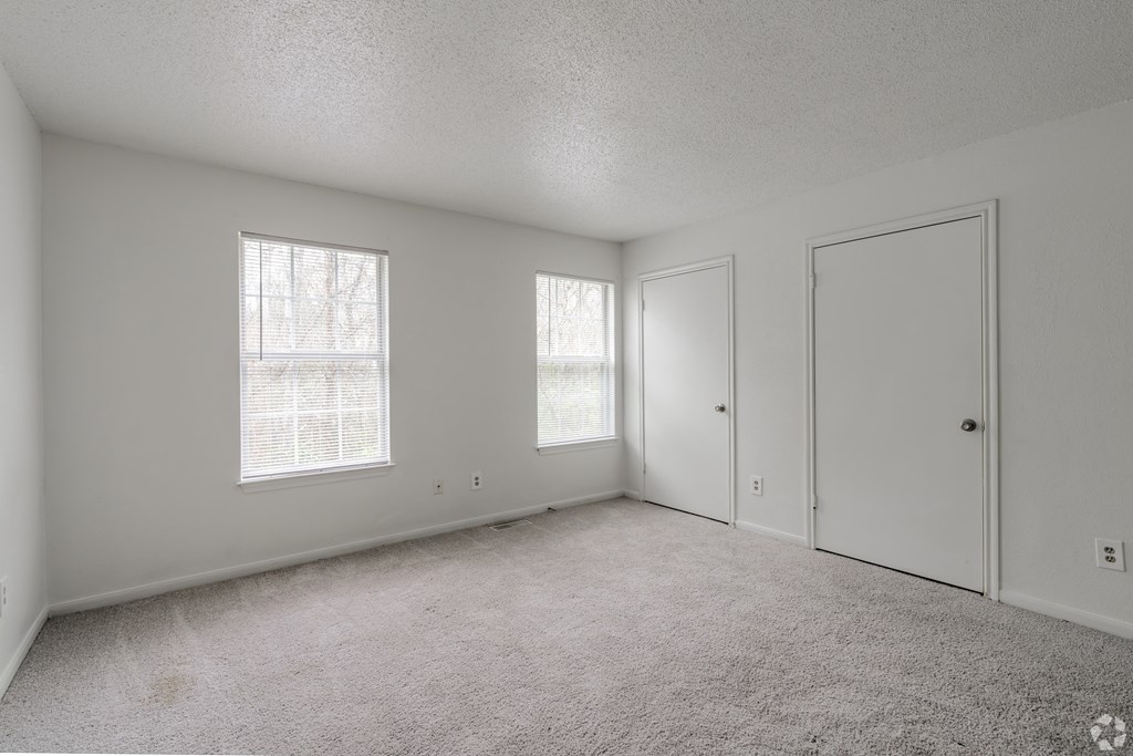 Bedroom with windows and doors at Greens of Concord, Concord, NC