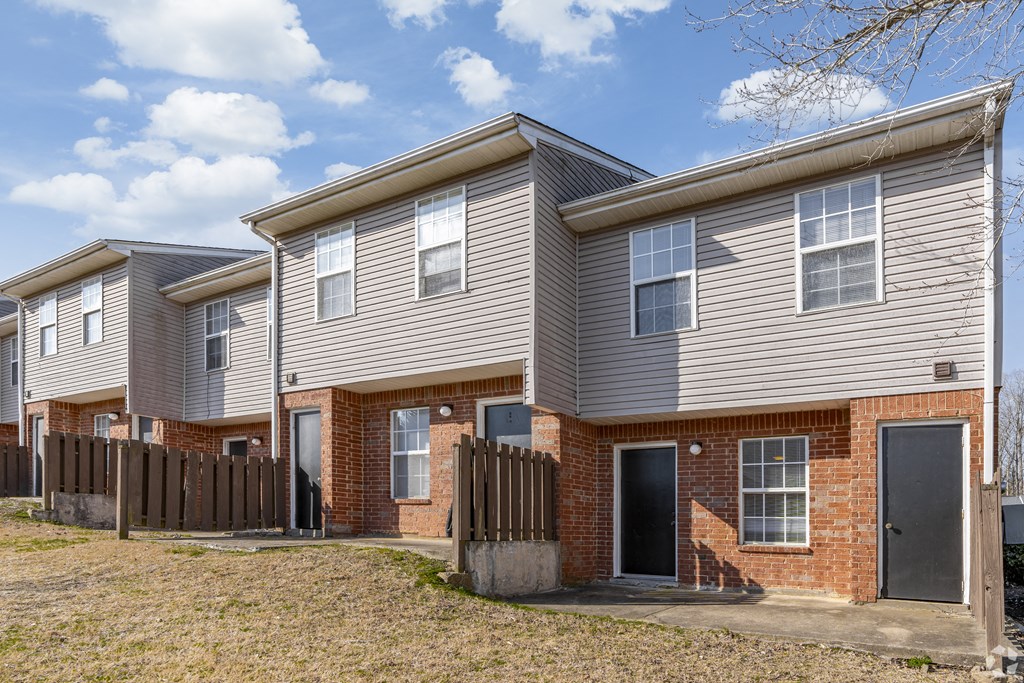 Exterior View of building with brick and and a wooden fence at Greens of Concord, Concord, North Carolina