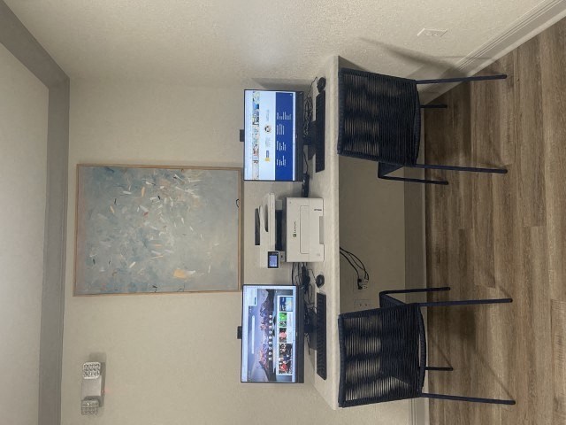 a living room with shelves on the wall