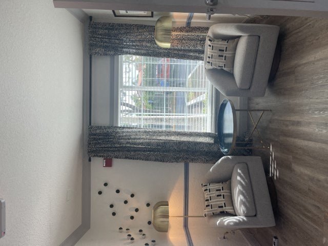 a bathroom with a window and a chair and a mirror