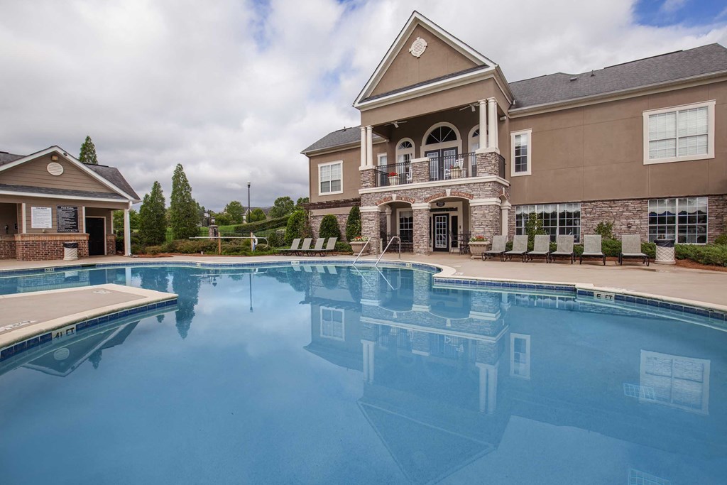 a large swimming pool in front of a house