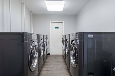 A row of washing machines in a laundromat.