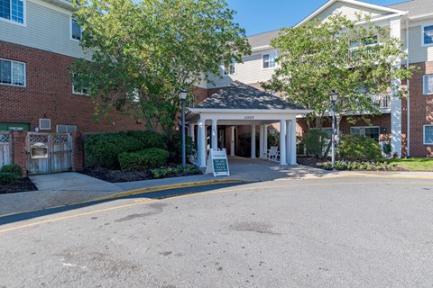 A building with a sign that says "Welcome" in front of it.
