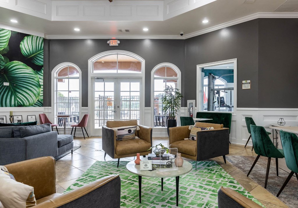 a resident clubhouse with couches chairs and a coffee table