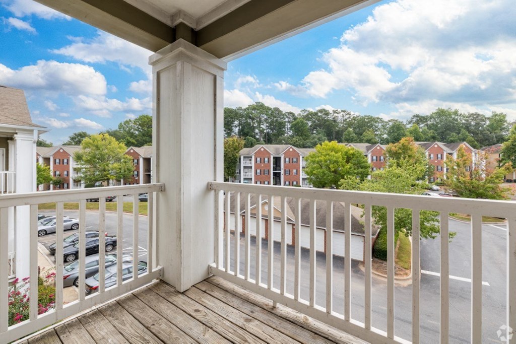 the view from the balcony of a home with a balcony railing at Magnolia Lake Apartments, Carrollton, GA