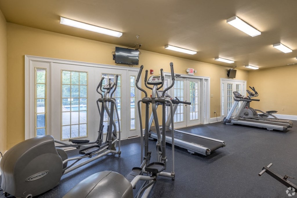 a gym with cardio equipment and windows at Magnolia Lake Apartments, Carrollton, 30117