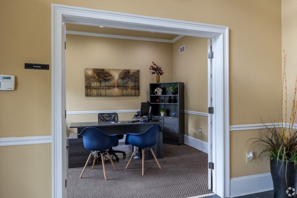 a room with a desk and chairs and a doorway at Magnolia Lake Apartments, Carrollton, GA