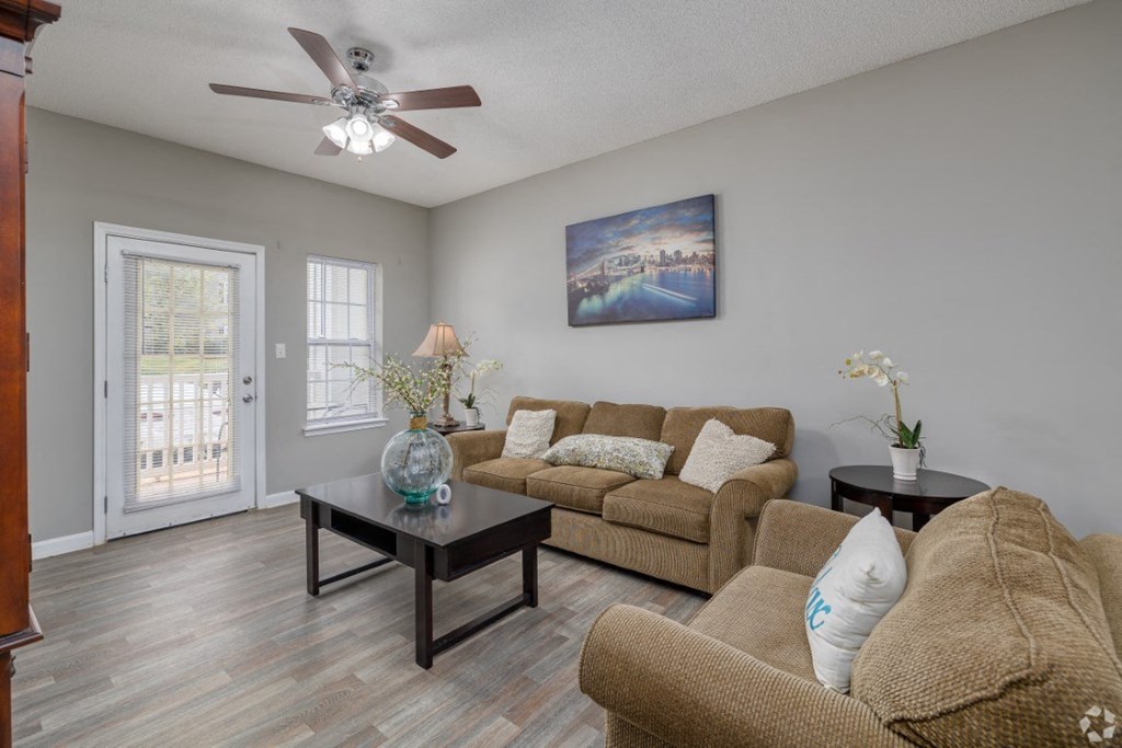 a living room with a couch and a table at Magnolia Lake Apartments, Carrollton, 30117