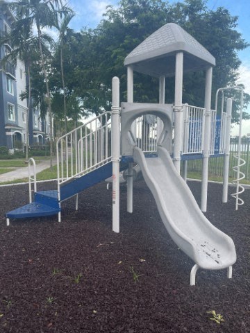 a childrens playground with a slide and