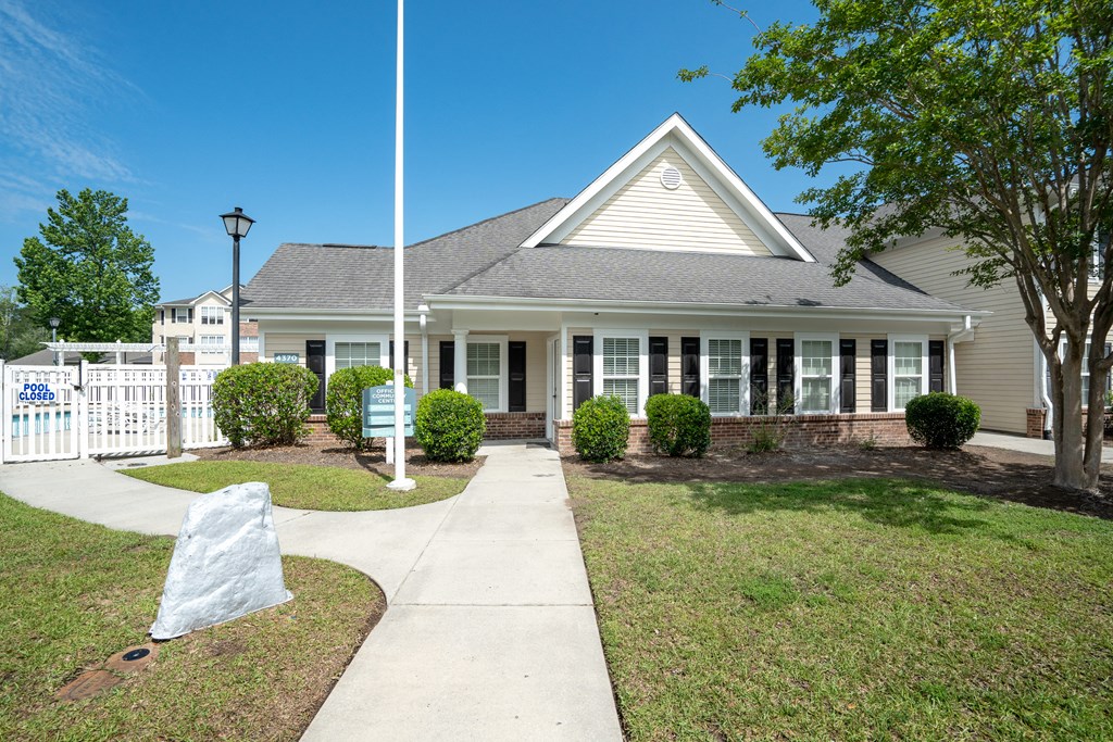 a house with a flagpole in front of it at Palms on Ashley River Apartments, Ladson