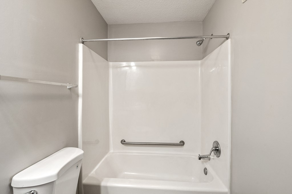 a bathroom with a bathtub and a toilet at Palms on Ashley River Apartments, South Carolina