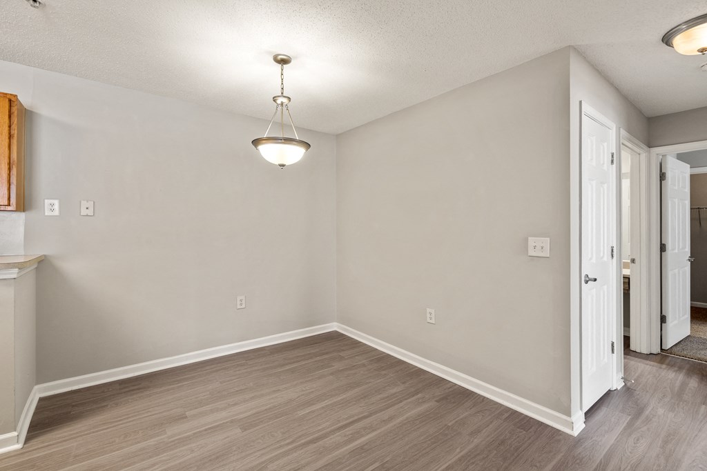 a bedroom with hardwood floors and grey walls at Palms on Ashley River Apartments, Ladson