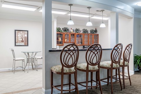 A dining room with a table and chairs.