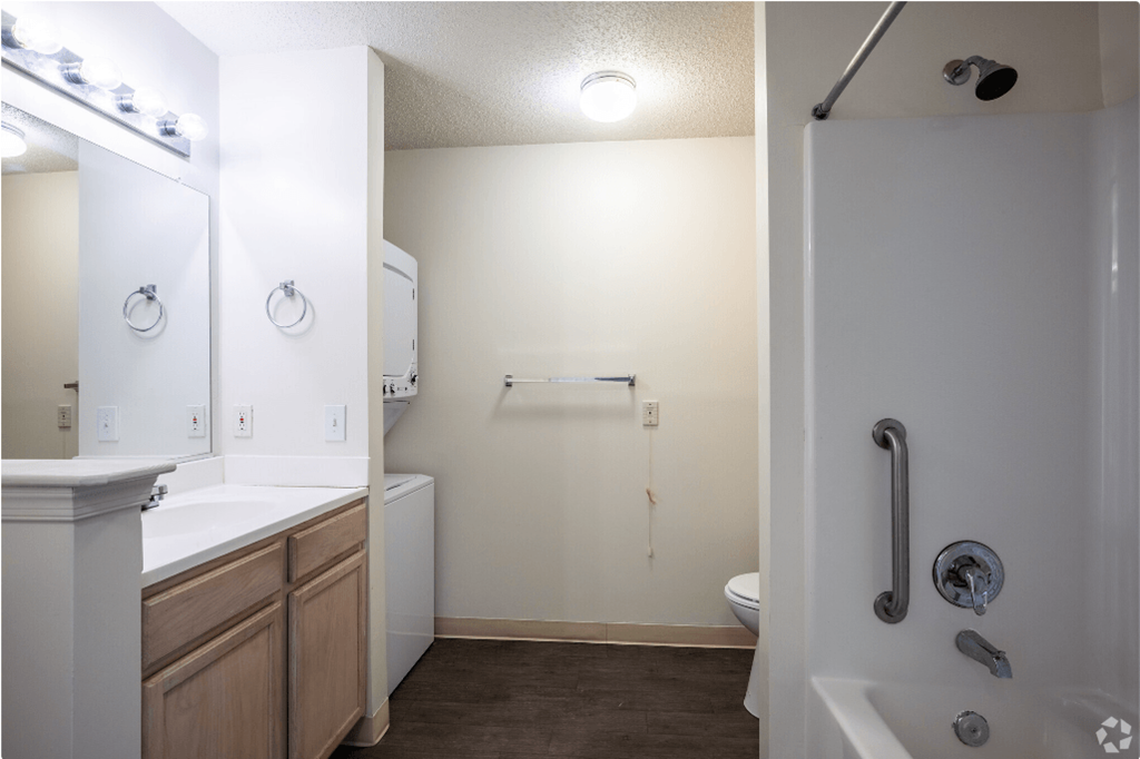 an empty bathroom with a shower and sink and a toilet