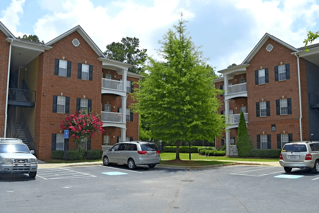 a parking lot in front of an apartment building