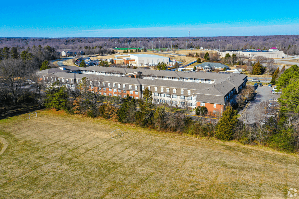 an aerial view of a large building in the middle of a field