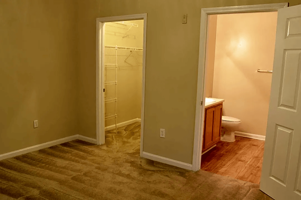 a bathroom with a shower and a door open