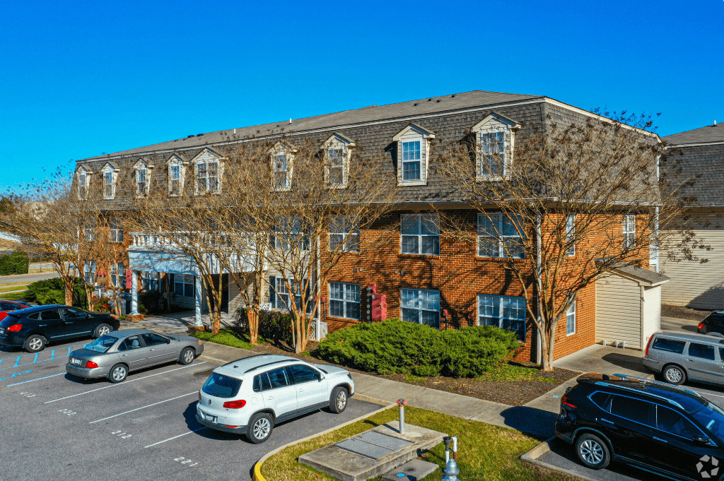 a large brick building with cars parked in front of it