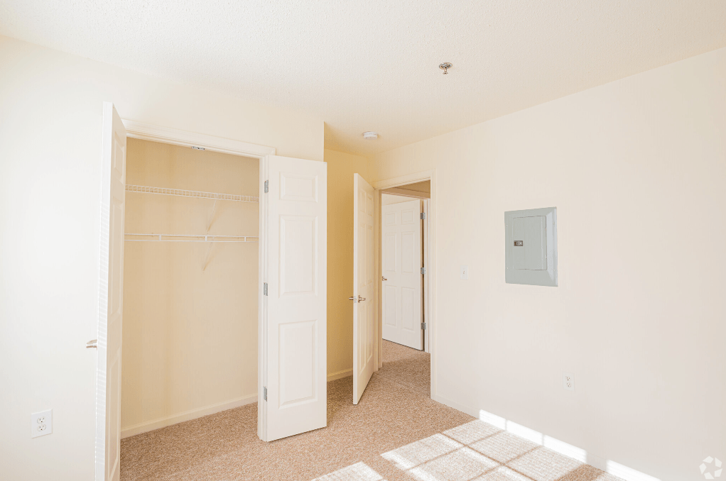 a bedroom with a closet and a door to a closet